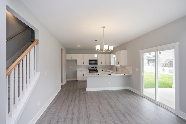 340 Fieldstone Ln, Springfield, TN 37172 - kitchen featuring stainless steel appliances, light wood-style floors, light countertops, tasteful backsplash, and recessed lighting