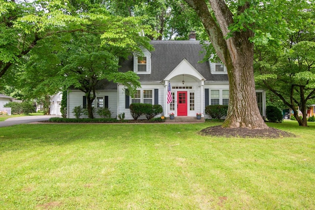 207 Cumberland Cir, Nashville, TN 37214 - view of front facade featuring a front lawn, driveway, a shingled roof, and a chimney
