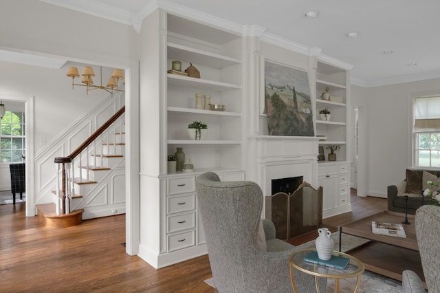 207 Cumberland Cir, Nashville, TN 37214 - living area featuring dark wood finished floors, crown molding, stairway, built in features, and a fireplace