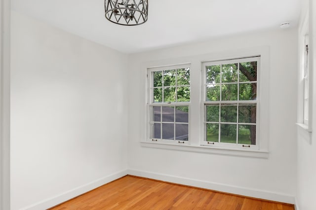 207 Cumberland Cir, Nashville, TN 37214 - unfurnished room with baseboards, light wood-type flooring, a chandelier, and a smoke detector