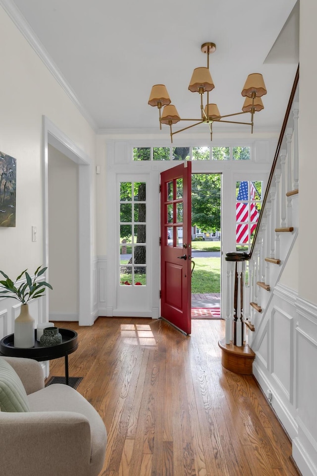 207 Cumberland Cir, Nashville, TN 37214 - entrance foyer featuring ornamental molding, stairway, a decorative wall, wood finished floors, and a chandelier