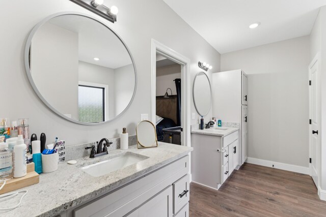 468 Olin Bean Rd, Red Boiling Springs, TN 37150 - bathroom featuring two vanities, wood finished floors, and baseboards