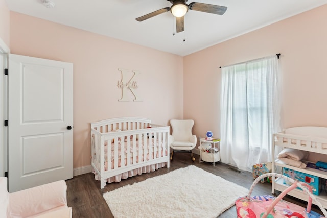 468 Olin Bean Rd, Red Boiling Springs, TN 37150 - bedroom featuring wood finished floors, a nursery area, baseboards, and a ceiling fan