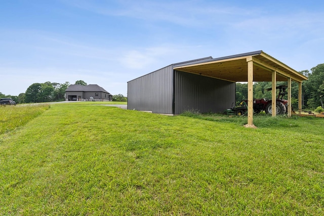 468 Olin Bean Rd, Red Boiling Springs, TN 37150 - view of green lawn with a carport, a pole building, and an outbuilding