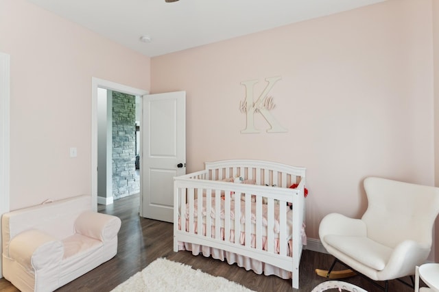 468 Olin Bean Rd, Red Boiling Springs, TN 37150 - bedroom featuring wood finished floors, a nursery area, and baseboards