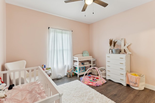 468 Olin Bean Rd, Red Boiling Springs, TN 37150 - bedroom featuring dark wood-type flooring, a crib, ceiling fan, and baseboards