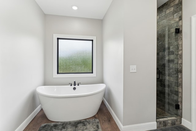 468 Olin Bean Rd, Red Boiling Springs, TN 37150 - bathroom featuring a stall shower, a soaking tub, wood finished floors, and baseboards