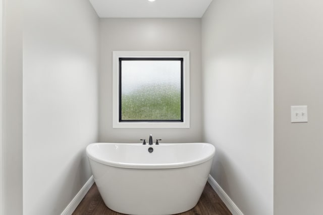 468 Olin Bean Rd, Red Boiling Springs, TN 37150 - bathroom featuring a freestanding bath, wood finished floors, and baseboards