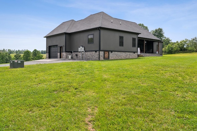 468 Olin Bean Rd, Red Boiling Springs, TN 37150 - back of house with a garage, driveway, a yard, and roof with shingles