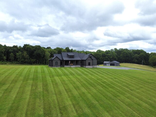 468 Olin Bean Rd, Red Boiling Springs, TN 37150 - back of house with a yard, an outbuilding, and a wooded view