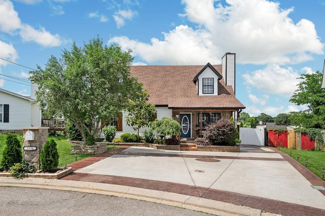 304 Hank Aaron Cv, La Vergne, TN 37086 - cape cod house featuring a chimney, a shingled roof, and a gate