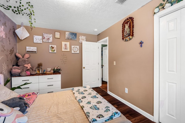 304 Hank Aaron Cv, La Vergne, TN 37086 - bedroom with dark wood-style flooring, a textured ceiling, and baseboards