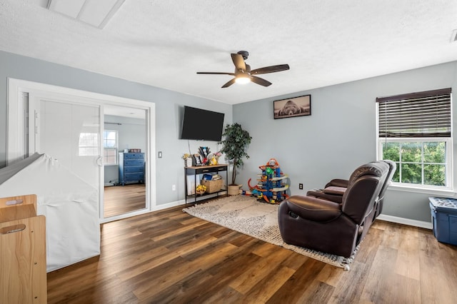 304 Hank Aaron Cv, La Vergne, TN 37086 - living room with a ceiling fan, wood finished floors, baseboards, and a textured ceiling