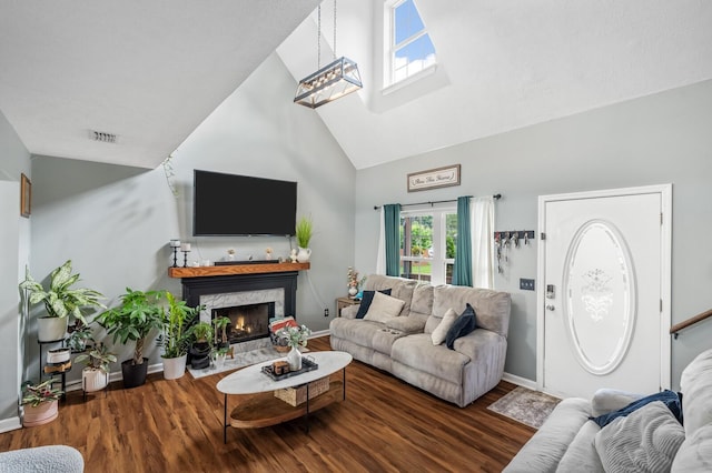 304 Hank Aaron Cv, La Vergne, TN 37086 - living area featuring high vaulted ceiling, wood finished floors, a fireplace, baseboards, and a skylight