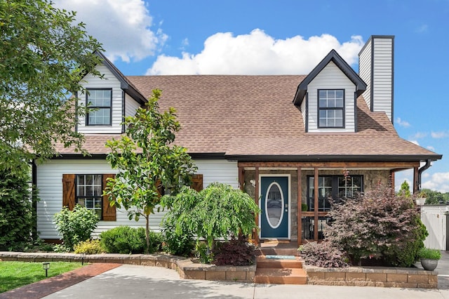 304 Hank Aaron Cv, La Vergne, TN 37086 - view of front facade with covered porch, a chimney, and a shingled roof
