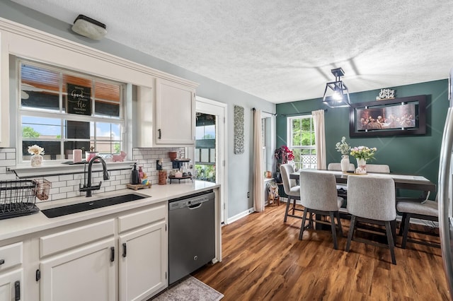 304 Hank Aaron Cv, La Vergne, TN 37086 - kitchen featuring dishwasher, a sink, decorative backsplash, dark wood finished floors, and white cabinets