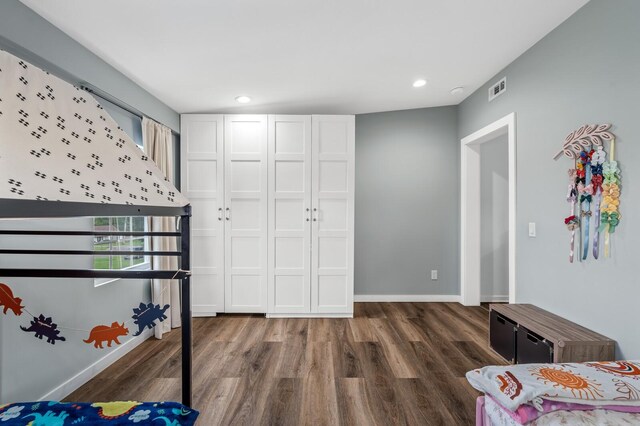 304 Hank Aaron Cv, La Vergne, TN 37086 - unfurnished bedroom with wood finished floors, multiple windows, baseboards, and recessed lighting