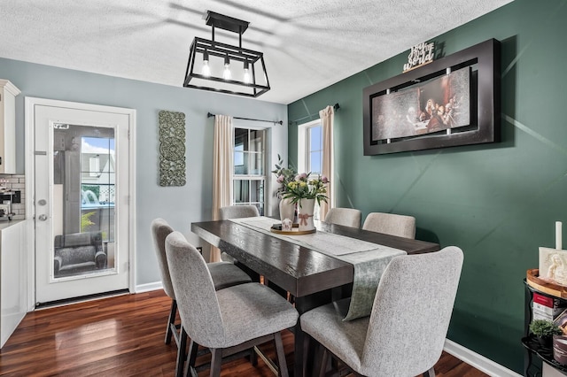 304 Hank Aaron Cv, La Vergne, TN 37086 - dining area with a textured ceiling, dark wood-type flooring, and baseboards