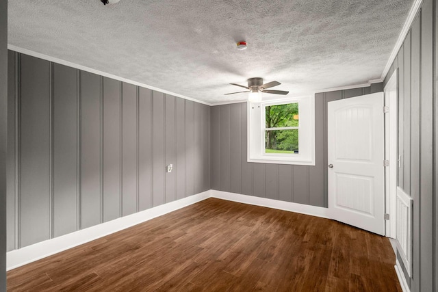 2607 Mashburn Ct, Nashville, TN 37210 - unfurnished room with a ceiling fan, dark wood-style flooring, baseboards, a textured ceiling, and a decorative wall
