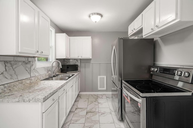 2607 Mashburn Ct, Nashville, TN 37210 - kitchen featuring stainless steel range with electric stovetop, a sink, light marble finish flooring, white cabinets, and light countertops