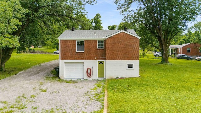 2607 Mashburn Ct, Nashville, TN 37210 - view of front of home featuring dirt driveway, an attached garage, a front yard, and brick siding