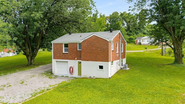 2607 Mashburn Ct, Nashville, TN 37210 - view of property exterior with brick siding, driveway, a garage, and a lawn