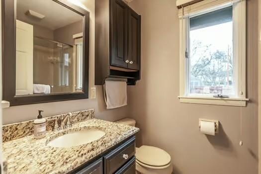 126 Harsh Ln, Castalian Springs, TN 37031 - full bathroom featuring toilet, vanity, and a shower with shower door