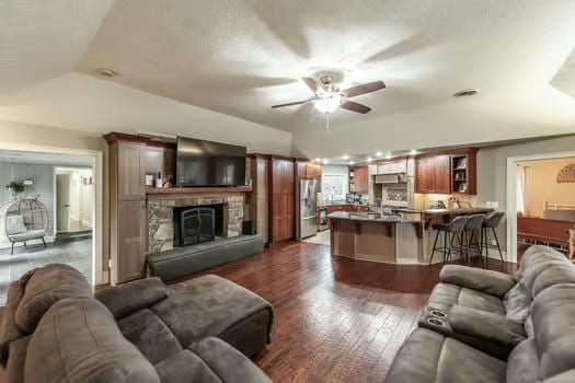 126 Harsh Ln, Castalian Springs, TN 37031 - living area featuring ceiling fan, dark wood-style flooring, and a stone fireplace