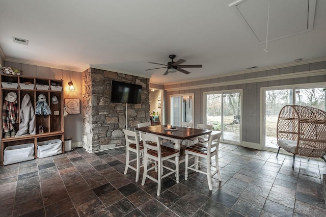 126 Harsh Ln, Castalian Springs, TN 37031 - dining area with attic access, crown molding, stone tile floors, a ceiling fan, and wood walls