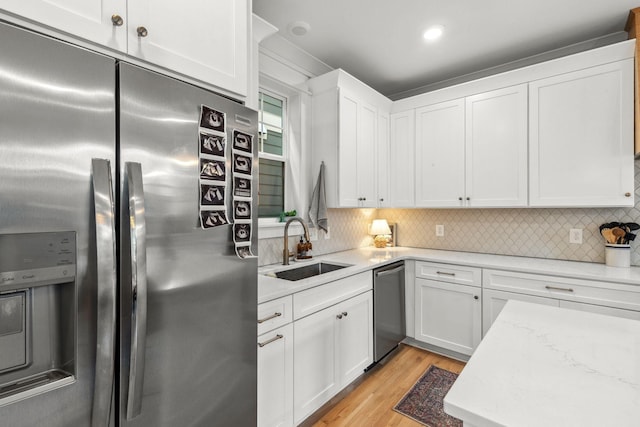 423A American Rd, Nashville, TN 37209 - kitchen with stainless steel appliances, a sink, white cabinets, and backsplash