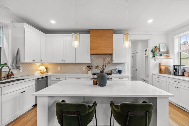 423A American Rd, Nashville, TN 37209 - kitchen featuring a sink, gas stove, a breakfast bar, white cabinets, and recessed lighting