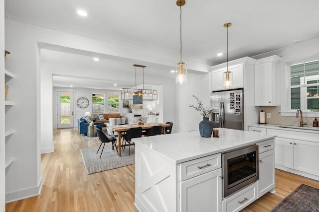 423A American Rd, Nashville, TN 37209 - kitchen with appliances with stainless steel finishes, a sink, decorative backsplash, recessed lighting, and light wood-style floors