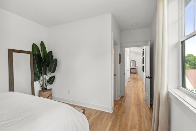 423A American Rd, Nashville, TN 37209 - bedroom featuring multiple windows, light wood-style flooring, and baseboards