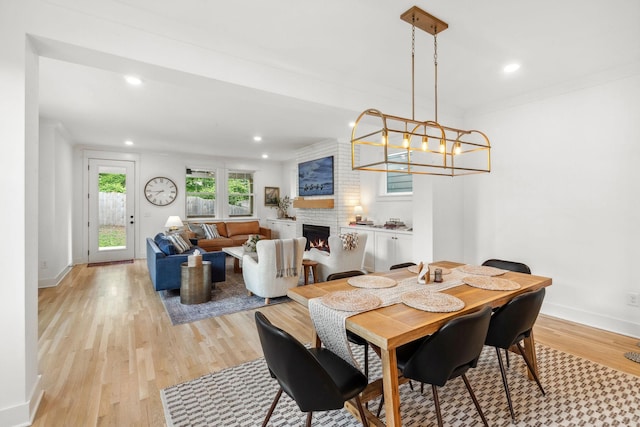 423A American Rd, Nashville, TN 37209 - dining area featuring light wood finished floors, a large fireplace, recessed lighting, baseboards, and a chandelier