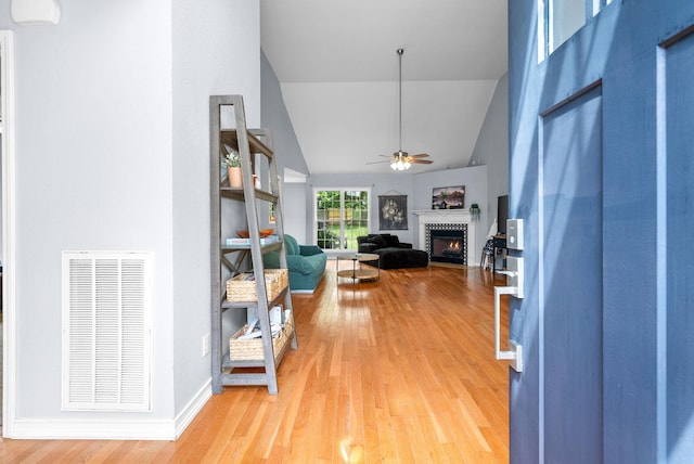 1052 Freedom Dr, Clarksville, TN 37042 - entryway featuring a warm lit fireplace, ceiling fan, light wood finished floors, and high vaulted ceiling