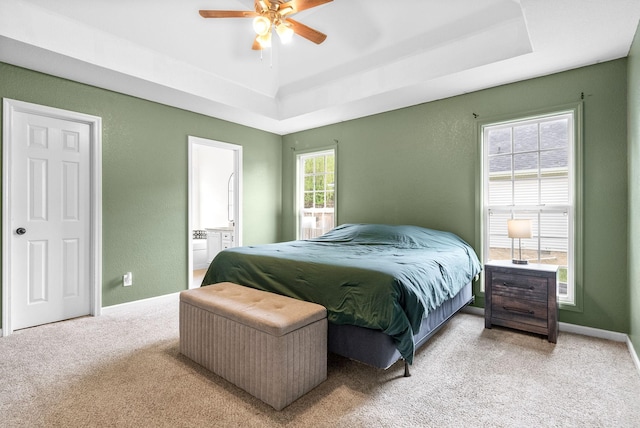 1052 Freedom Dr, Clarksville, TN 37042 - carpeted bedroom featuring a raised ceiling, baseboards, ensuite bath, and a textured wall