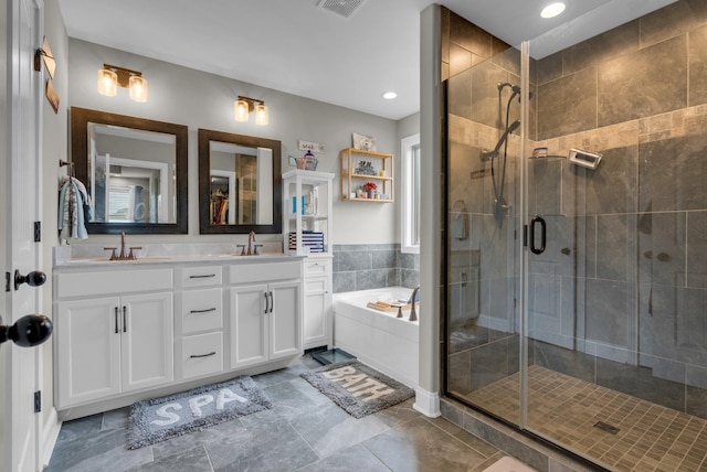 3555 Neena Ct, Clarksville, TN 37042 - bathroom featuring a garden tub, double vanity, a stall shower, and recessed lighting