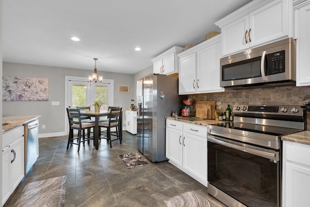 3555 Neena Ct, Clarksville, TN 37042 - kitchen featuring appliances with stainless steel finishes, a chandelier, decorative backsplash, white cabinets, and recessed lighting