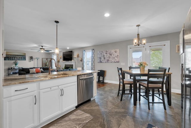 3555 Neena Ct, Clarksville, TN 37042 - kitchen featuring dishwasher, a sink, open floor plan, a fireplace, and baseboards