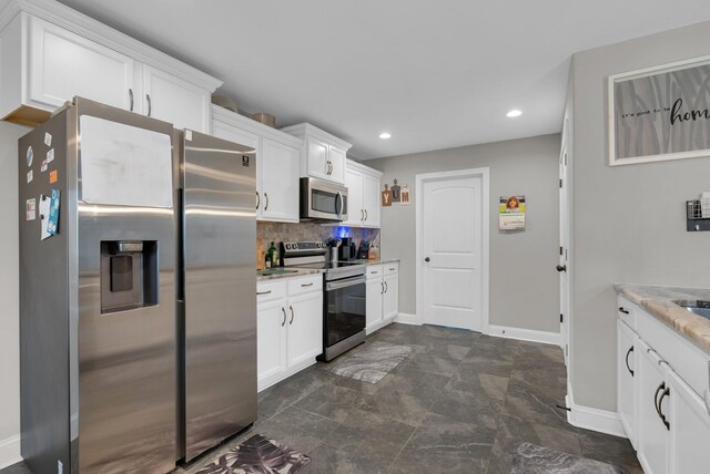 3555 Neena Ct, Clarksville, TN 37042 - kitchen featuring stainless steel appliances, white cabinets, baseboards, recessed lighting, and backsplash
