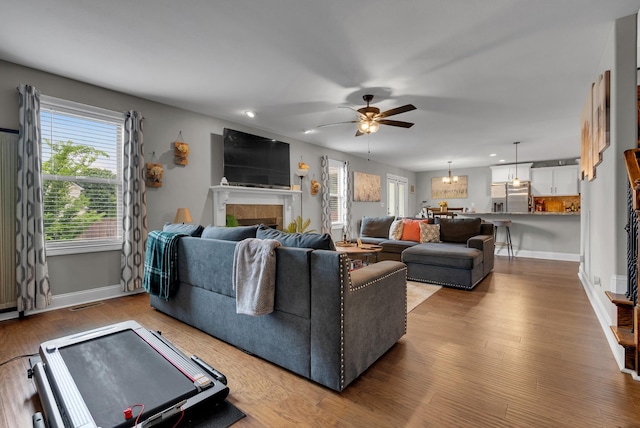 3555 Neena Ct, Clarksville, TN 37042 - living room featuring a ceiling fan, a tile fireplace, recessed lighting, wood finished floors, and baseboards