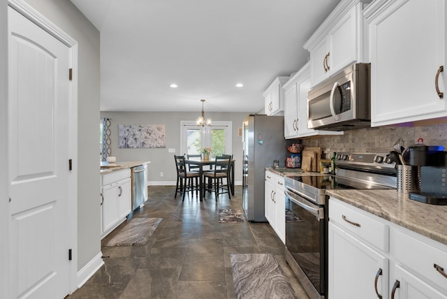 3555 Neena Ct, Clarksville, TN 37042 - kitchen featuring stainless steel appliances, white cabinets, baseboards, a chandelier, and recessed lighting