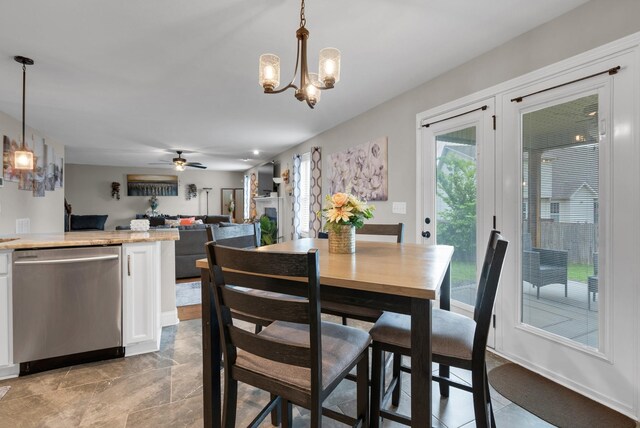 3555 Neena Ct, Clarksville, TN 37042 - dining space featuring a chandelier, a ceiling fan, and light stone finish flooring