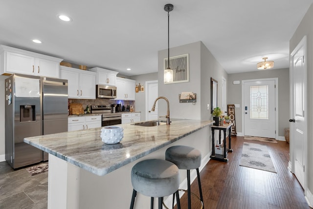 3555 Neena Ct, Clarksville, TN 37042 - kitchen with stainless steel appliances, a sink, baseboards, a kitchen breakfast bar, and light stone countertops