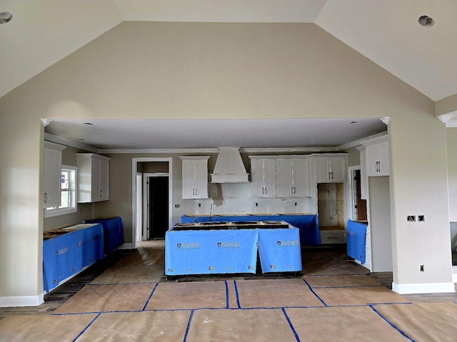 4003 Kelley Farris Rd, Columbia, TN 38401 - kitchen with a center island, premium range hood, high vaulted ceiling, white cabinetry, and ornamental molding