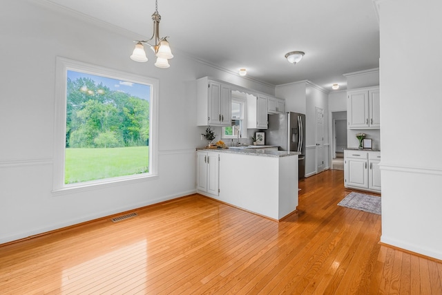 8560 Coopertown Rd, Joelton, TN 37080 - kitchen with a chandelier, a peninsula, light wood-style flooring, ornamental molding, and a sink