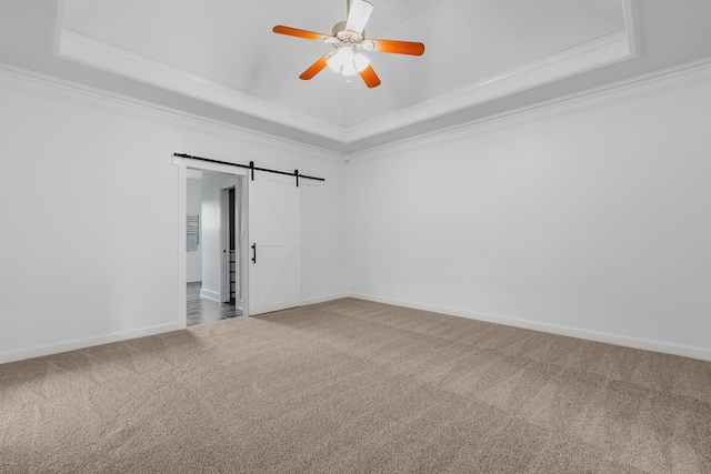 8560 Coopertown Rd, Joelton, TN 37080 - carpeted empty room featuring a raised ceiling, crown molding, ceiling fan, a barn door, and baseboards