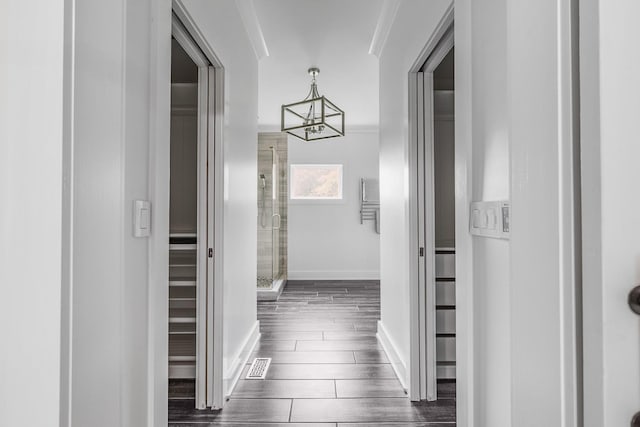 8560 Coopertown Rd, Joelton, TN 37080 - hall featuring a chandelier, dark wood-type flooring, and baseboards