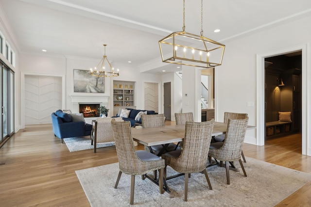 8118 Heirloom Blvd, College Grove, TN 37046 - dining room featuring a chandelier, recessed lighting, light wood finished floors, built in shelves, and ornamental molding