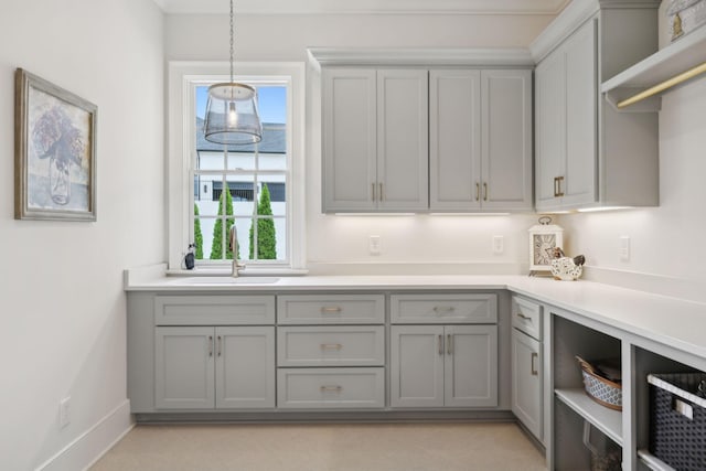 8118 Heirloom Blvd, College Grove, TN 37046 - kitchen with gray cabinetry, a sink, plenty of natural light, and hanging light fixtures